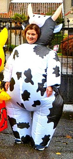 As the inspiration for recalling this colorful incident in Westmorelands history, this unidentified marcher in a cow suit paused in front of the Crematorium in passage down S.E. 14th, in the October 27th Moreland Monster March.