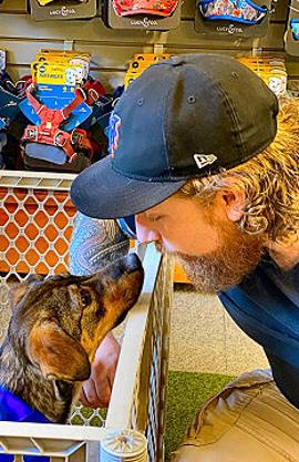 Store employee Ben Dunning meeting Ukrainian rescue dog Carolina (Cora).