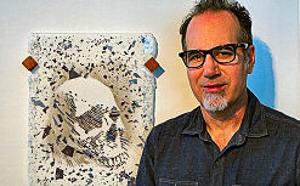 Bullseye Glass employee Robert James, one of this years three Gold Award artists, stands with his glass sculpture, The Years Have Not Been Kind.