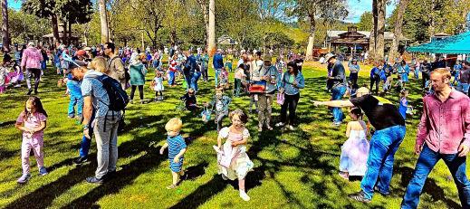 And off they all go, scooping up eggs, after the timed signal to start hunting  at the 2025 SMILE Egg Hunt, held at Oaks Amusement Park.
