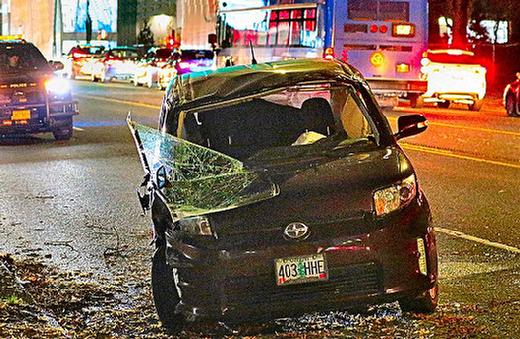 After hitting the curb on westbound S.E. Powell Boulevard for some reason, and then rolling over, this battered Scion xB subcompact sedan was tipped back onto its wheels by a few husky bystanders, allowing traffic on the busy highway to proceed. The occupants of the wrecked car gathered their possessions from inside it, and then just ambled off.