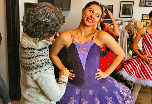 Volunteer Classical Ballet Academy costumer Cathy Ono fits a ballet costume to her daughter, Issa Ono, who is a student at Grant High School.