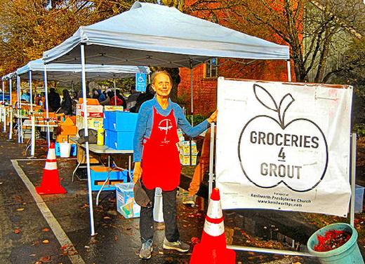 During our visit on November 22nd, six tables were set up under canopies  filled with food pantry items  at Kenilworth Presbyterian Church, to serve needy community members. Laura Schaefer, standing to the left of the sign, has been the director of Groceries 4 Grout since the onset of COVID-19