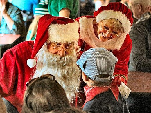 Jolly Santa and Mrs. Claus greet kids during every Holiday Express trip along the east side of the Willamette River.