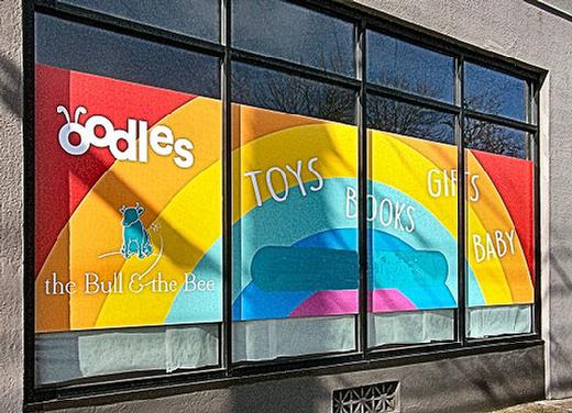 The colorful new front window of the Oodles For Kids toy store  6237 S.E. Milwaukie Avenue, at Tolman  in Westmoreland.