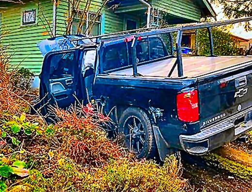 Here�s the stolen Chevrolet Silverado, its door open and its hood up, stopped inside a front yard near Tolman and 72nd, after his nearby head-on crash ended his crime spree. He tried to hide nearby, but was quickly sniffed out by a police K-9, and was arrested.