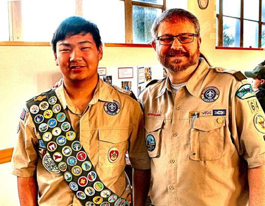New Troop 64 Eagle Scout Daniel Schaller is congratulated by Craig Vanderbout, the Advancement Coordinator for the B.S.A. troop.
