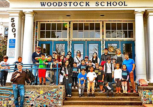 Parents and students of Woodstock Elementary School gathered here on its front steps to express their discontent with severe reductions looming for its eminently successful, nationally-recognized Mandarin Immersion Program.