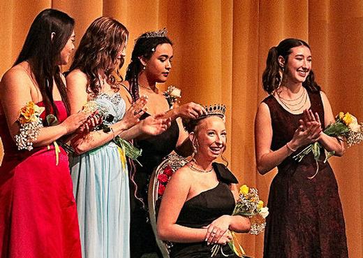 Last years CHS Rose Festival Princess, Zora Forsberg, stepped up to place the Princess Tiara upon the head of this years Princess, Sabrina Johnson  surrounded by the rest of her court.