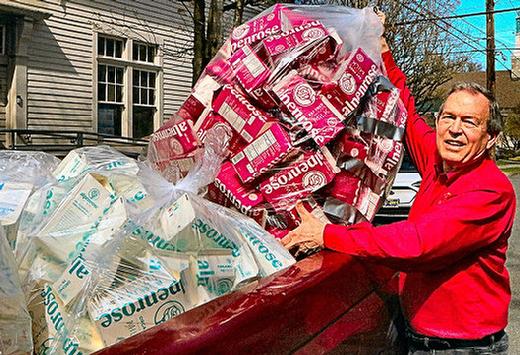 Here with a bag of sealed  but empty  milk cartons for use in building boats to race in June at the Royal Rosarian Milk Carton Boat Races, we found Royal Rosarian Bob Strader! This free carton distribution to contestants began in late March at the Sellwood Community House, and at three Les Schwab Tire Stores, including the one in Sellwood.