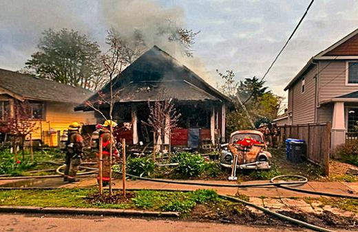 A flash-over in the front room of this Foster-Powell neighborhood house charred the interior. Smoke belched from the roof through the holes firefighters cut to release hot, combustible gasses from what was left of the home.