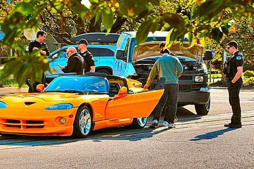 Officers, and the people from the car dealership where this eye-catching used car was for sale, gathered  after the yellow 2001 Dodge Viper GTS sports car, out on a test drive, was rear-ended by a van on S.E. 17th at the entrance to Garthwick, at the southern end of Sellwood.