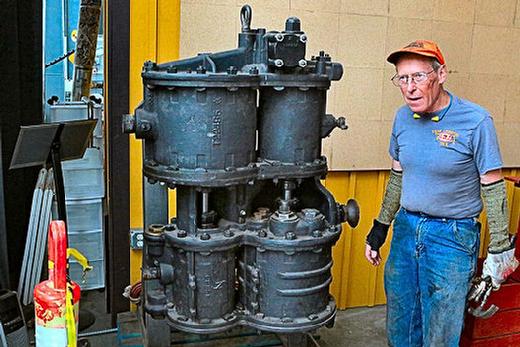 Pacific Railroad Preservation Association Manager Jim Vanderbeck stands alongside one of the of the massive air compressor pumps for the �700� that�s already been refurbished, and is ready to install. These compressors are what put on the brakes when the engine needs to stop!