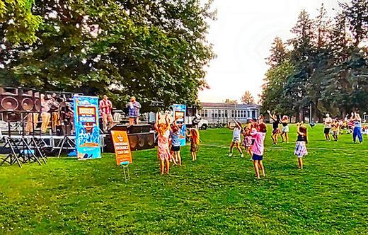 On August 8th the energetic, local, and hot Latin band Conjunto Alegré came to Woodstock Park for a summer Free For All concert. People of all ages enjoyed the music, and danced to the rhythms of salsa and merengue. Woodstock Elementary School is visible in the background.