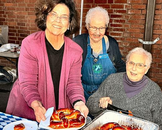 Pretzel ladies Lidia Aragon, Bea Burk, and Cam Hanemann provided these traditional hot snacks to one and all at the Eastmoreland Oktoberfest held at Holy Family Catholic Church on September 21st  the last day of summer.