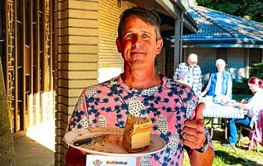 Proudly showing what remained of his grand-prize-winning Cinnamon Snickerdoodle Cake after attendees tasted it was neighborhood home baker Nate Calkins, at the Reed Neighborhood Associations Fall Festival.