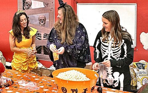 Getting treats ready for kids, at the Holy Family Catholic School Halloween Carnival, were these parent volunteers  Katrina Rask, Christine Pechette, and Lyn Hart.