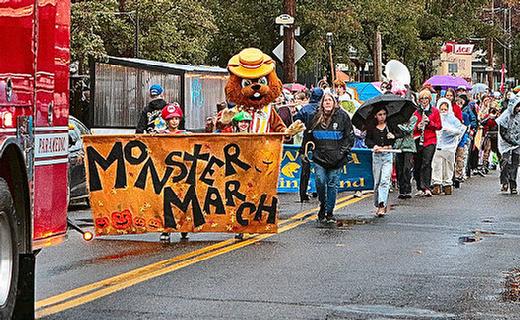 Following Westmoreland Fire Station 20s Engine at its head, the Monster March parade splashes through the Westmoreland business district.