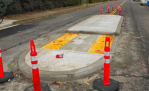 Hours after a fatal overnight motor scooter accident, someone left a small flower memorial at the brand-new traffic island, into which the victim had crashed in the dark.