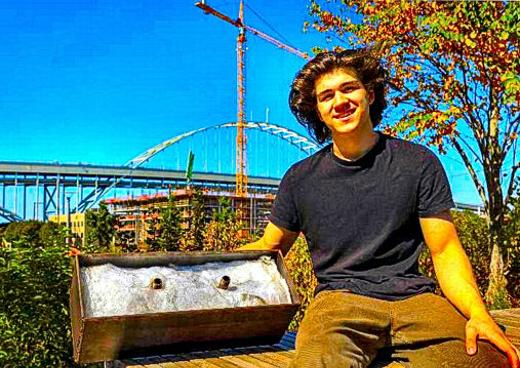 Charlie Abrams, a Cleveland High senior, started nonprofit �Recycled Living� to build tiny homes for the homeless. He also built the machines to create the building materials out of recyclable plastic. Here, he shows off the form into which the warm recycled plastic is pressed to create sturdy bricks for construction.