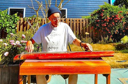 Woodstock�s Jim Binkley has played and constructed Chinese guqins for over three decades. The one he was playing here was made of redwood salvaged from a 19th Century cabin in California. He also built the table, made from Pacific Northwest red cedar.