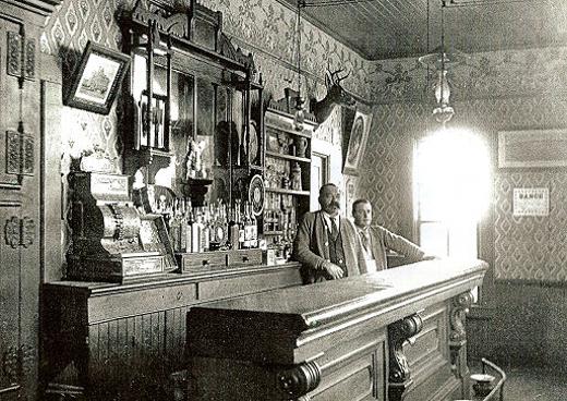 Early days of the Gottschalk Café and Beer Parlor. When Prohibition was enforced in Oregon from 1916 to 1933, saloon owners had to rely on soft drinks and food to pull in customers. The two men here in the bar are Wilhem Gottschalk on the left, and his son George Gottschalk.